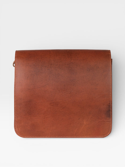 Brown leather bag on a white background