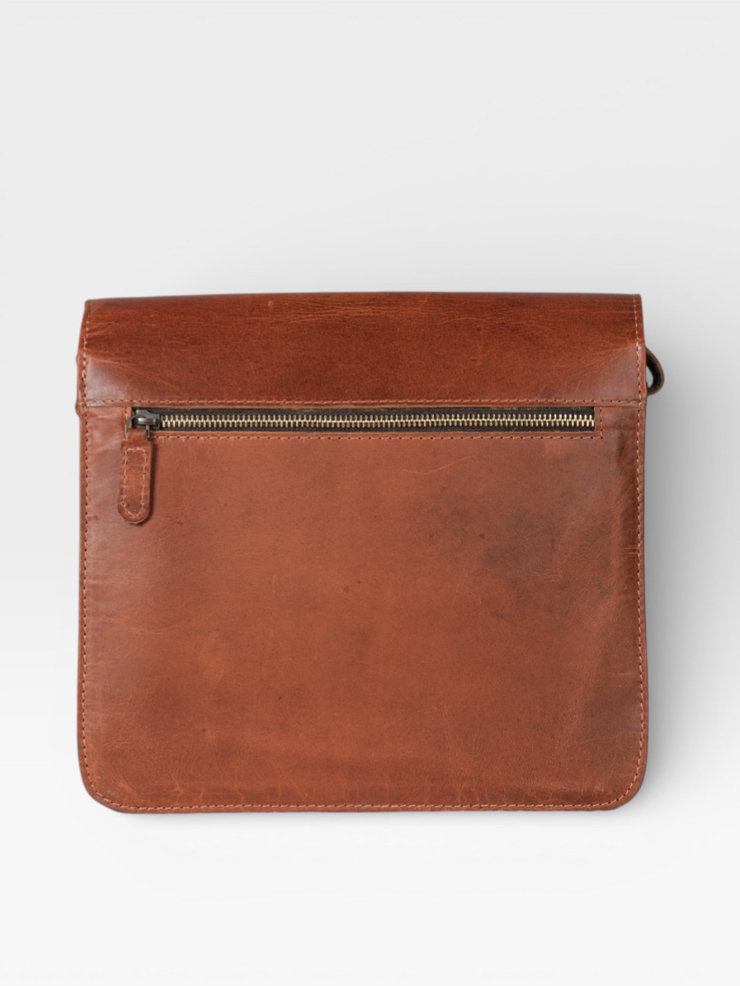 Brown leather pouch with a zipper on a light gray background